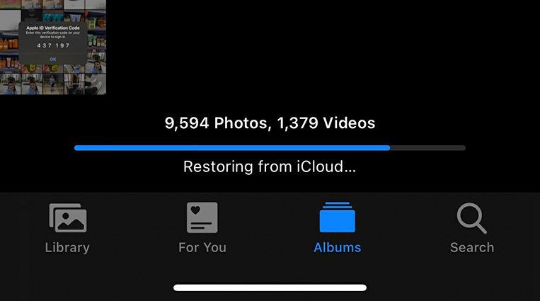 Why does my iPhone photos say restoring from iCloud